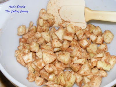 Mixing chopped apples in a bowl.