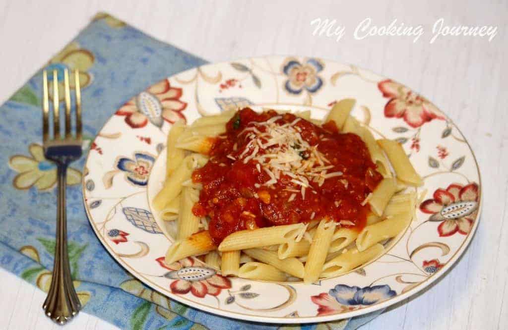 Penne All ‘Arrabbiata in a plate with spoon