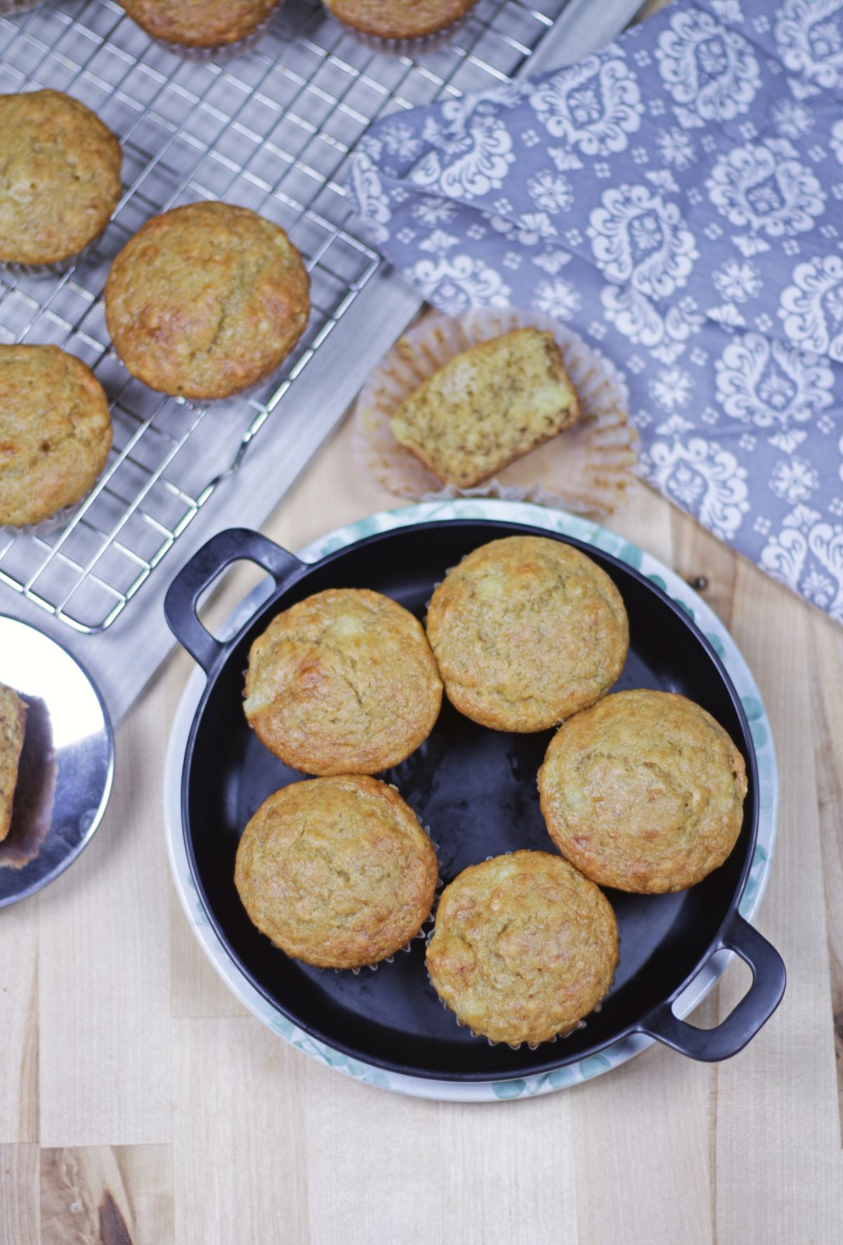 5 muffins in a plate and more in a rack in the background