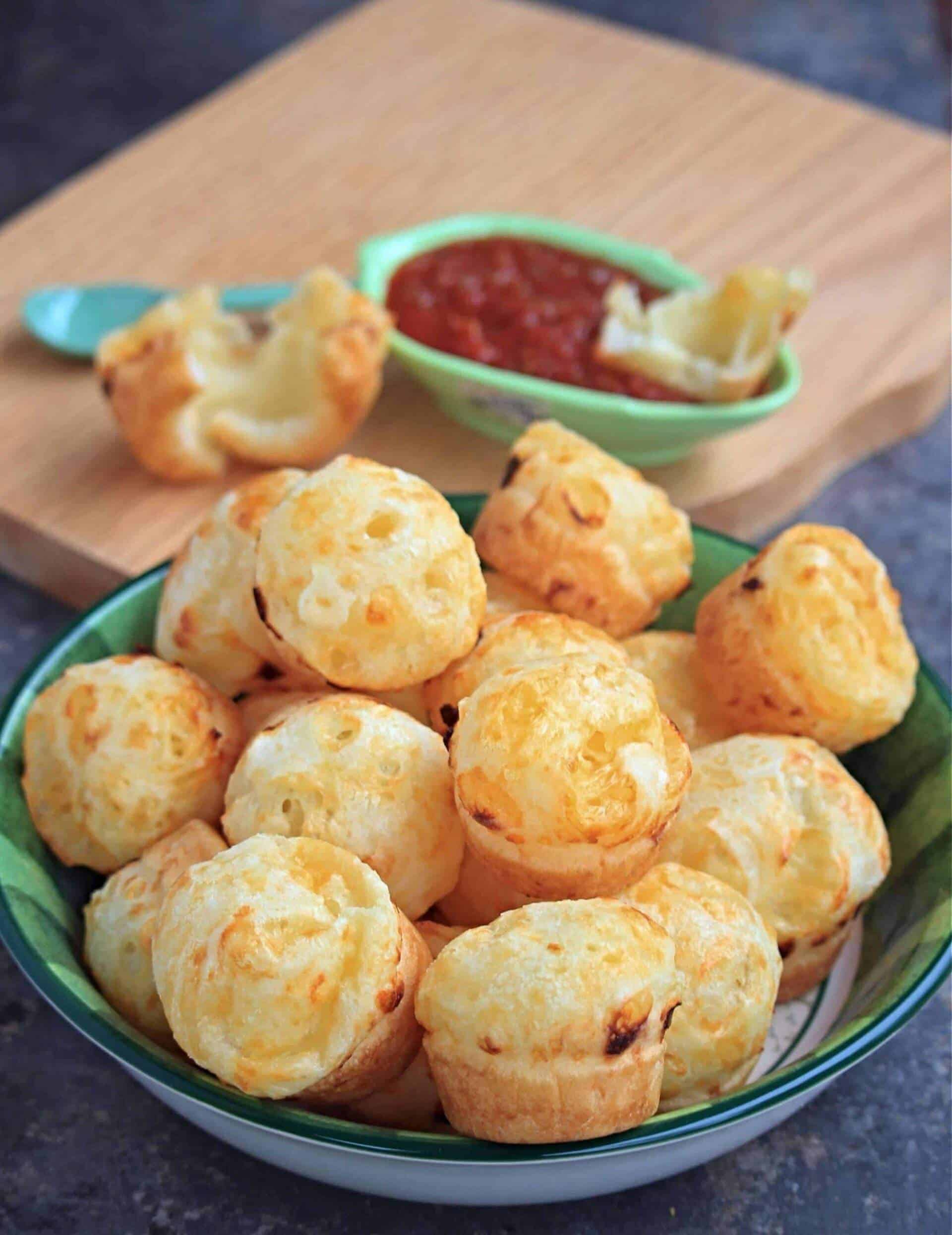 Brazilian cheese bread in a bowl and dipped in salsa