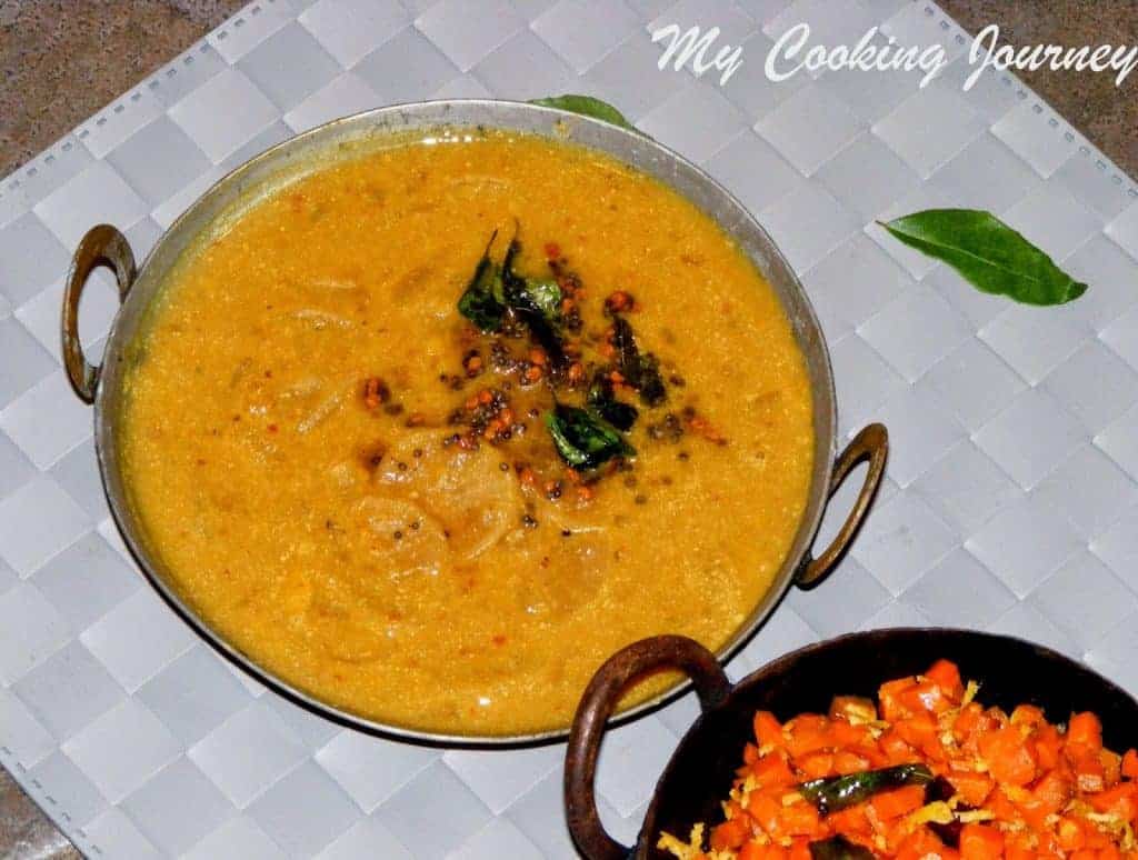 Carrot curry and Vendhaya sambhar in a pan with some bhaji