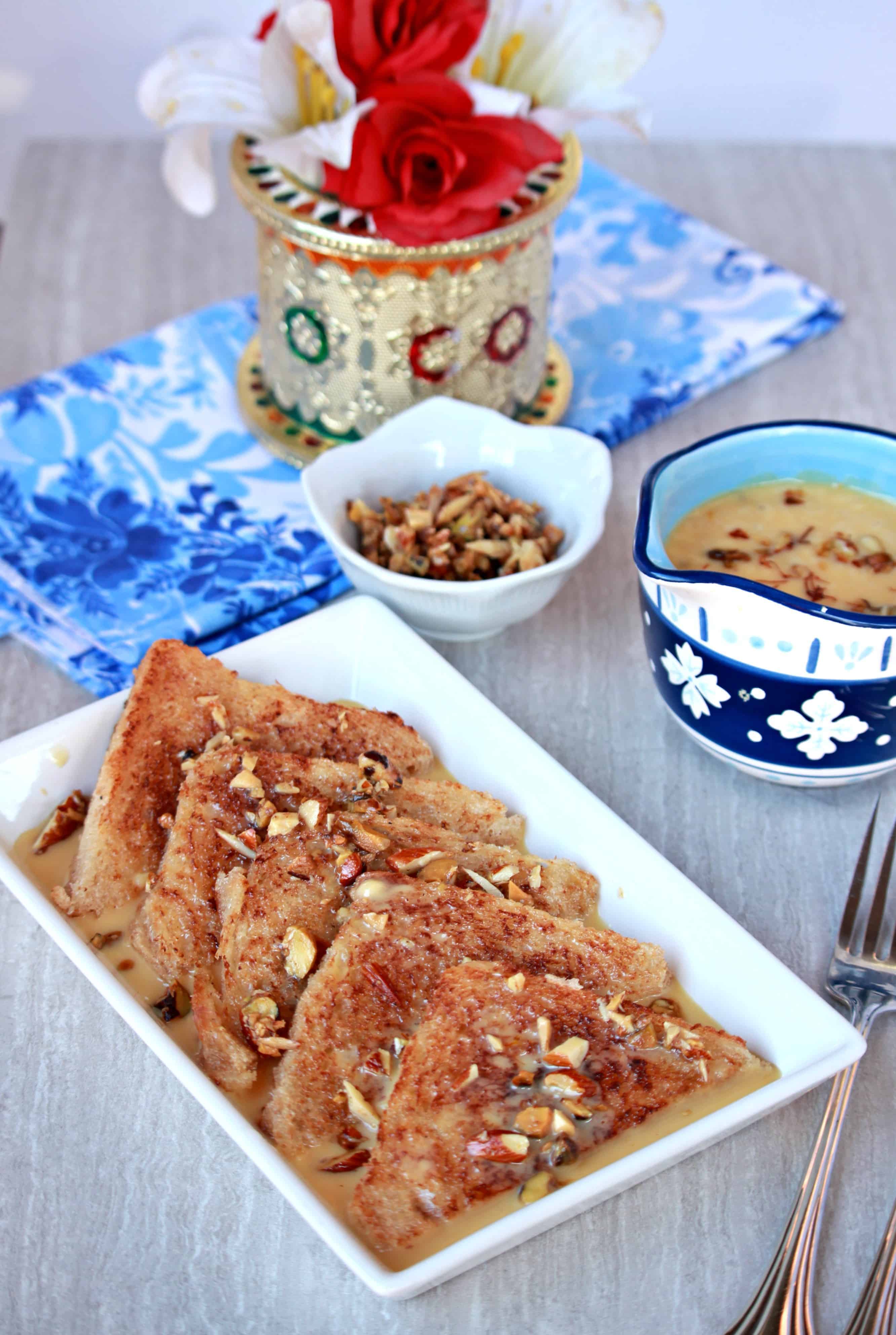 Double Ka Meetha in a white plate with nuts and milk mixture on the side