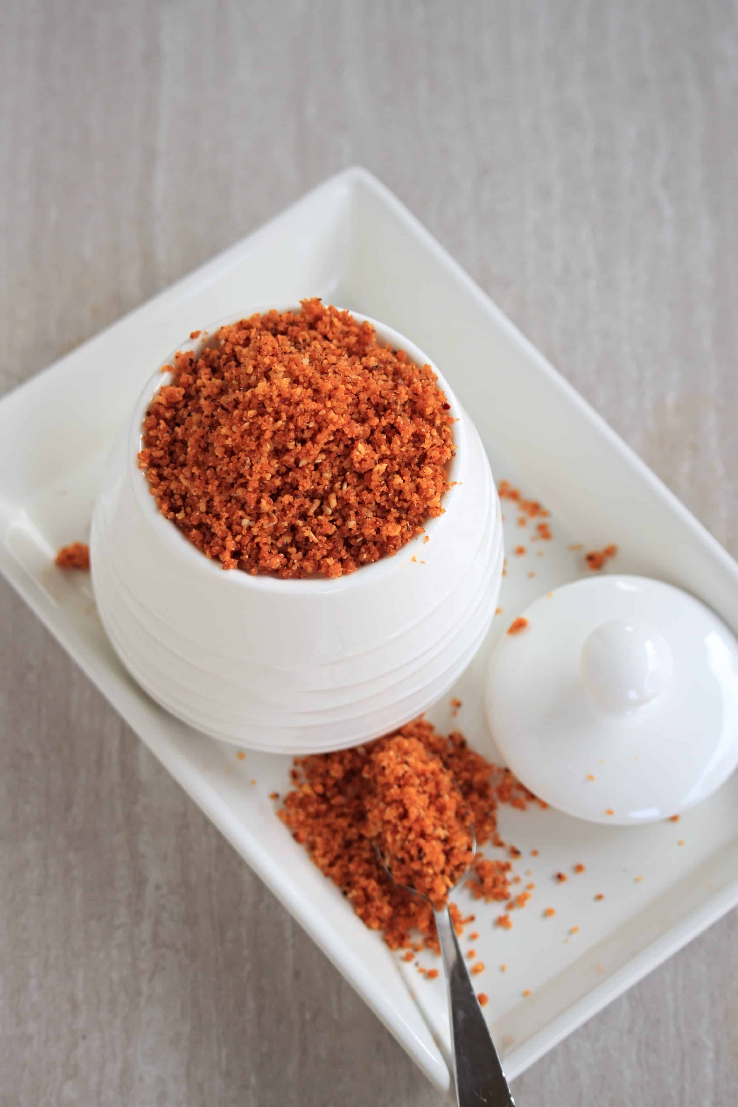 garlic chutney powder in a white bowl on a white plate