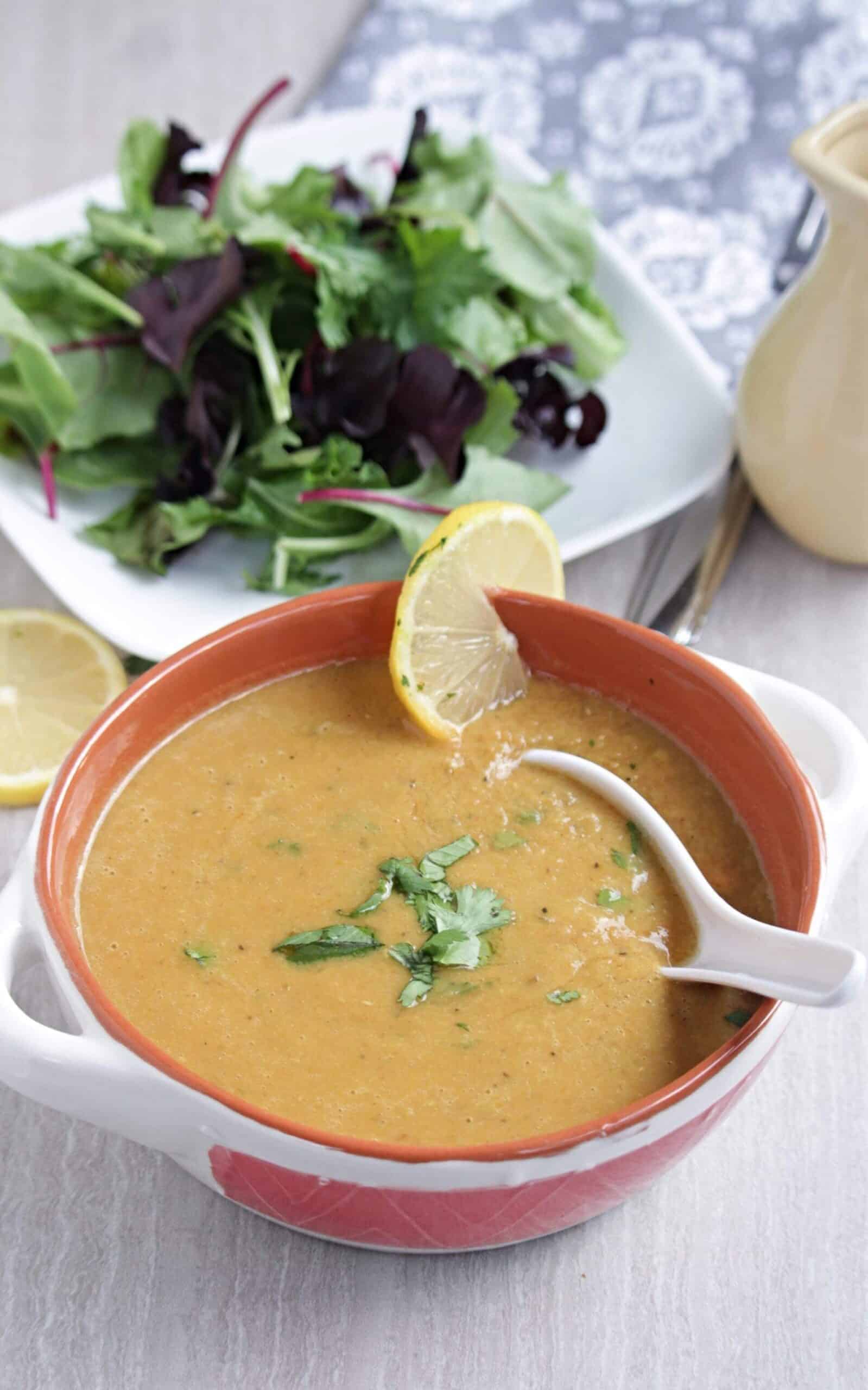 Middle eastern vegan soup with a salad in the background