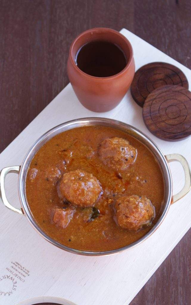 Spicy Chettinad style Urundai Kuzhambu in a metal bowl