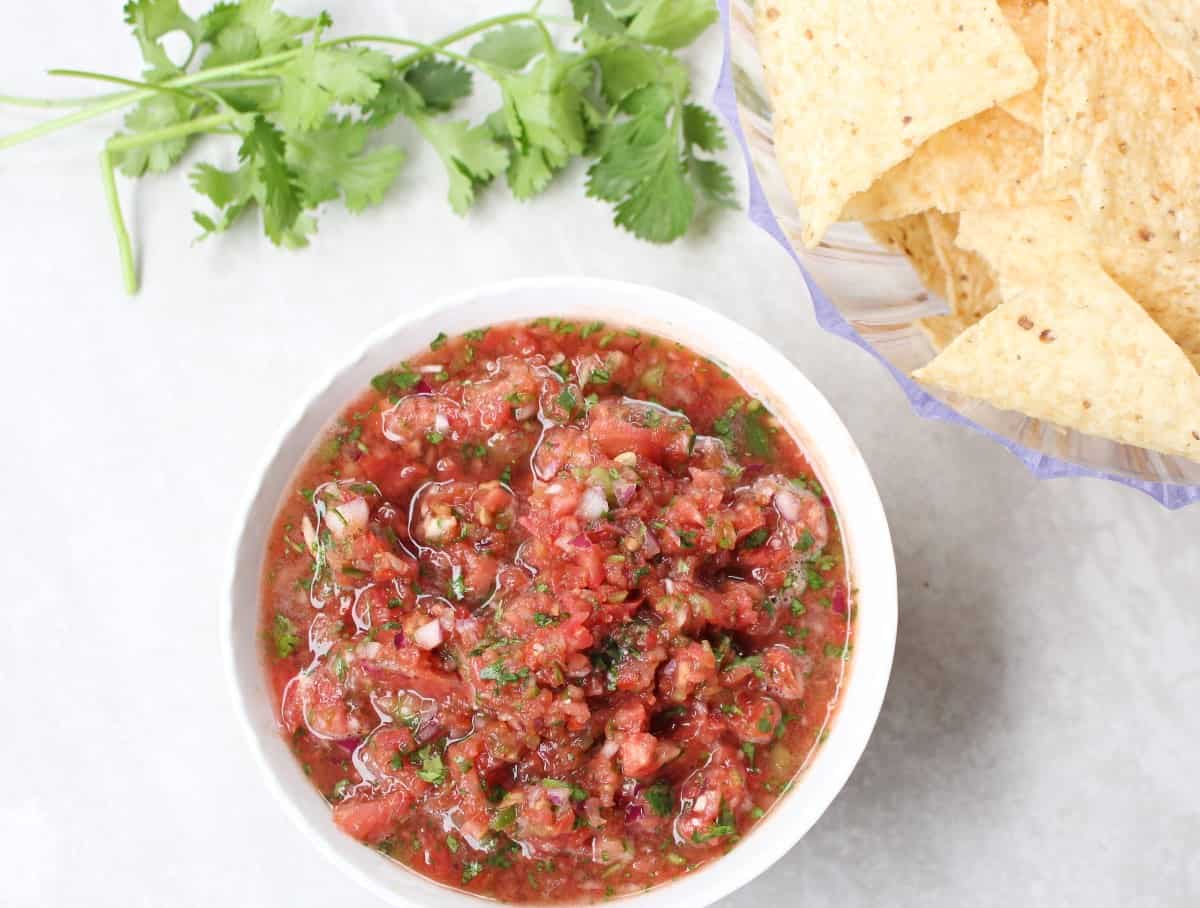 Tomato salsa in a bowl with chips