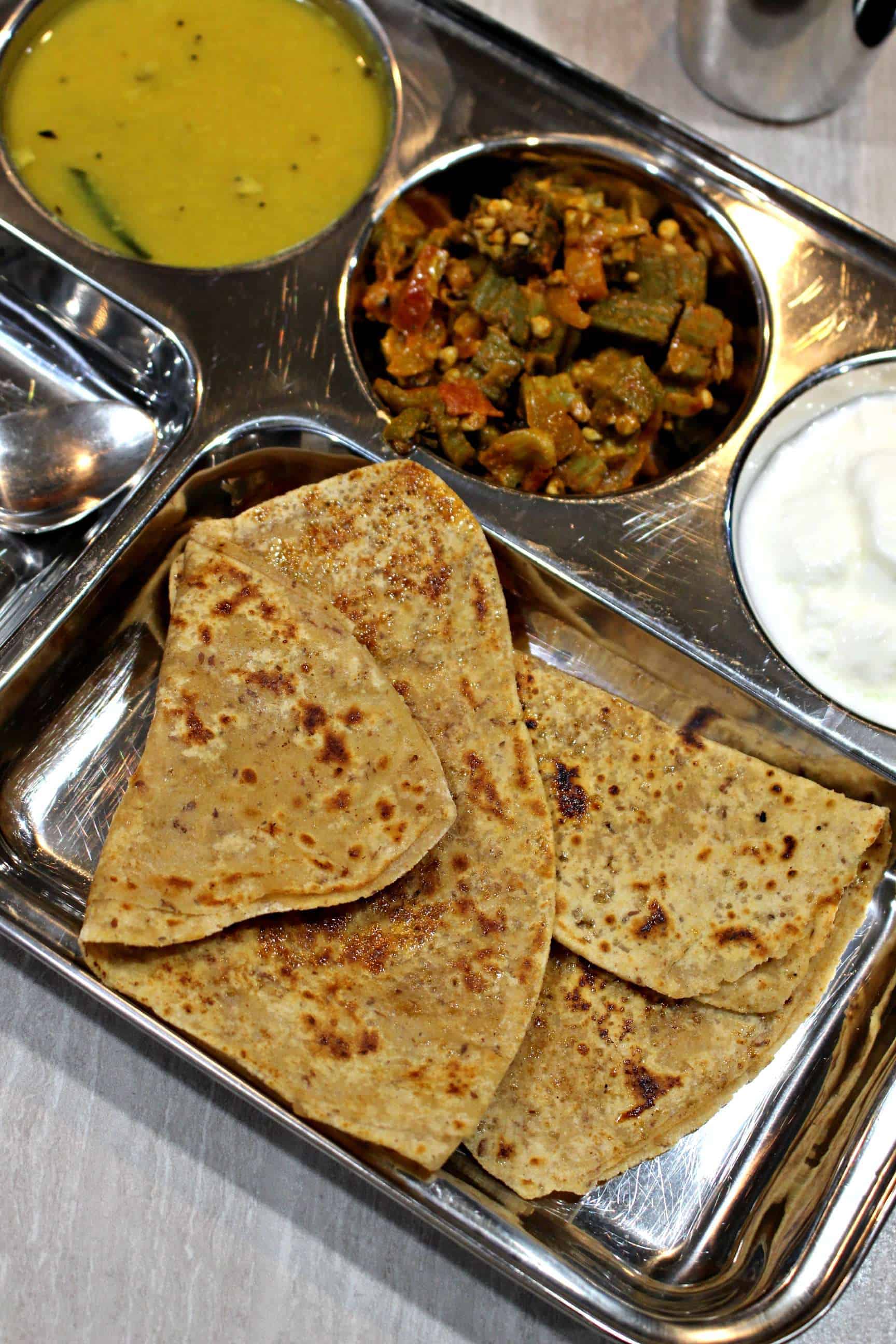 Sweet Roti with sides of Okra, Raita and Dal