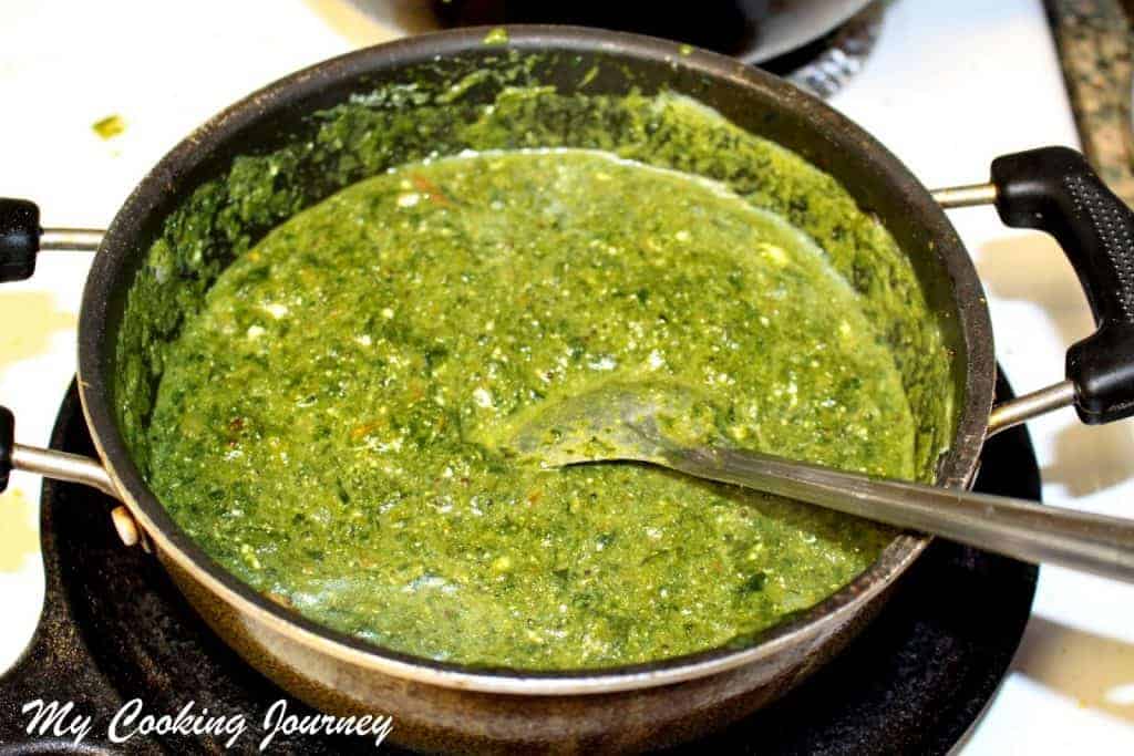 Boiling cooked spinach.